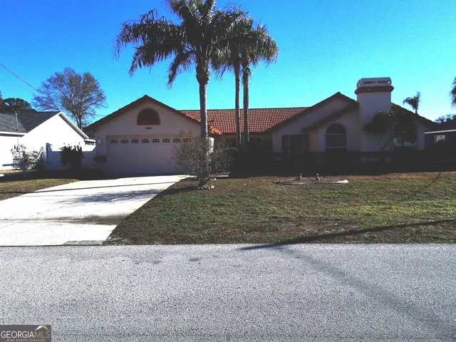 a front view of house with yard and trees
