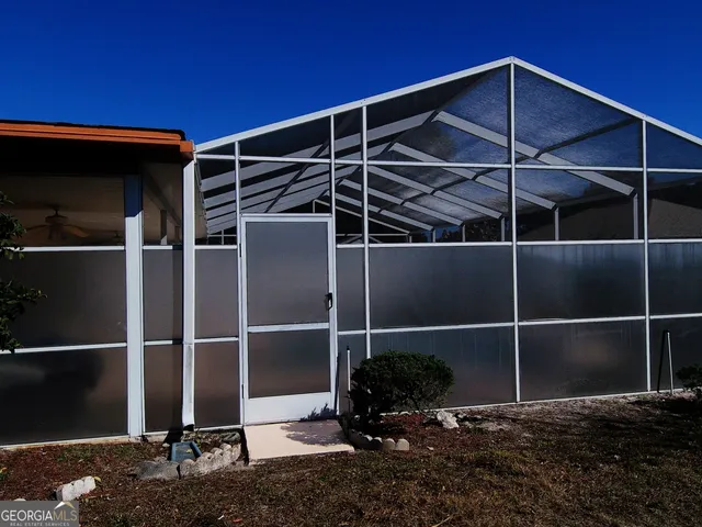 a view of a dining room with furniture wooden floor and chandelier