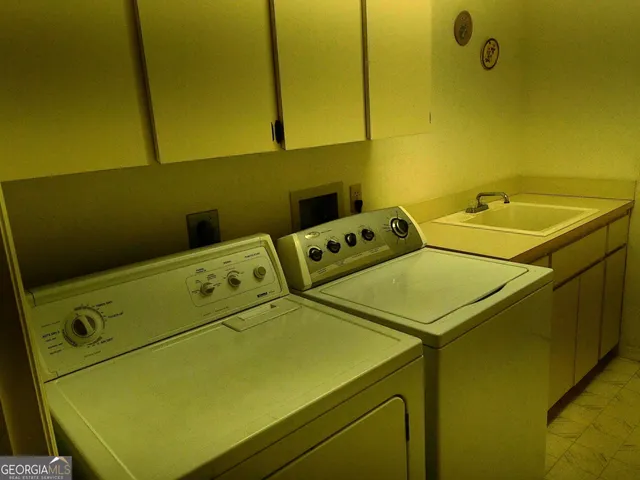 a bedroom with a bed a mirror on dresser and a large window