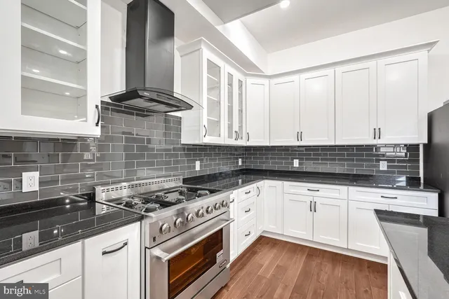 a kitchen with granite countertop a sink and cabinets