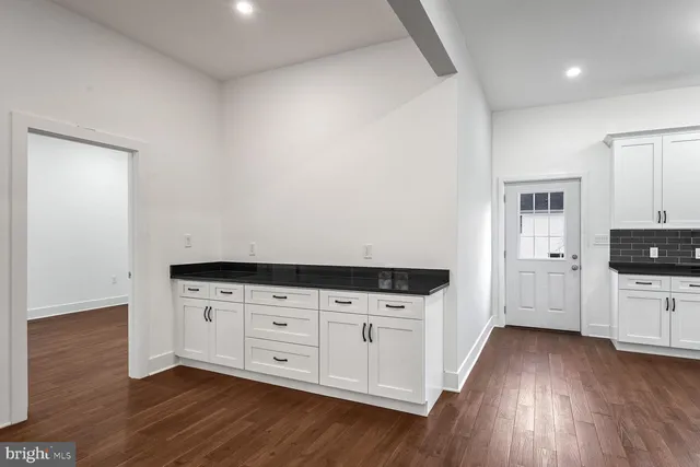 a view of an entryway with wooden floor