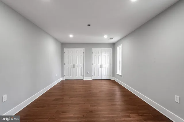 a room with walk in closet and wooden floor