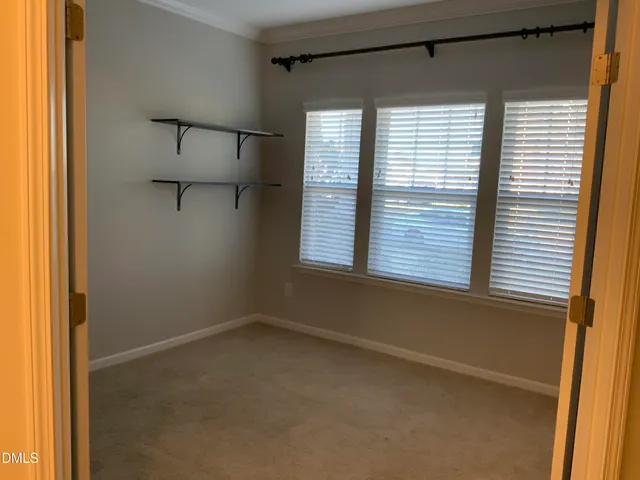 a kitchen with a kitchen island a sink wooden floor and a window