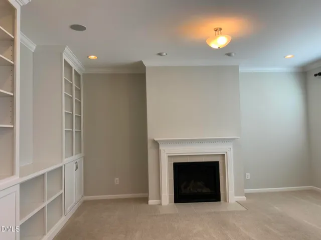 a view of empty room with a fireplace