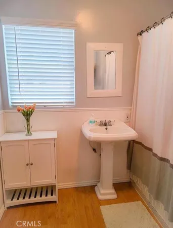 a bathroom with a sink a mirror and a shower