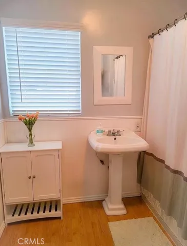 a bathroom with a sink a mirror and a shower