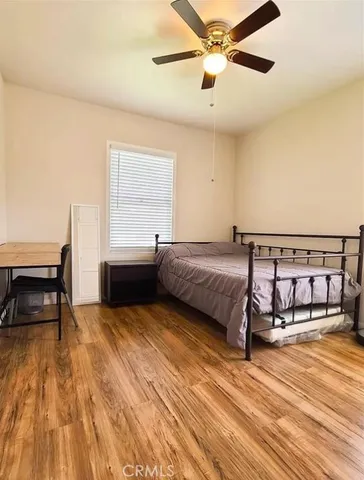a bedroom with a bed and a view of balcony