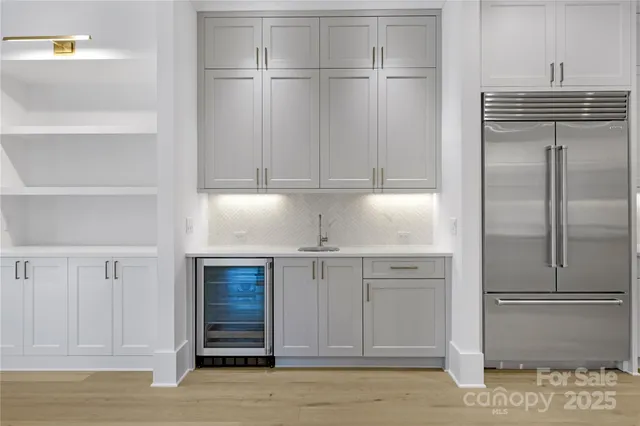 a kitchen with cabinets and stainless steel appliances