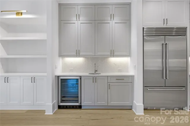 a kitchen with cabinets and stainless steel appliances