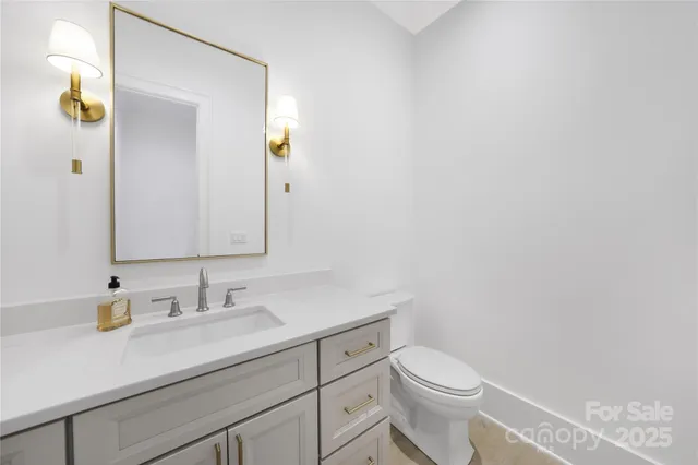 a bathroom with a sink a toilet and mirror