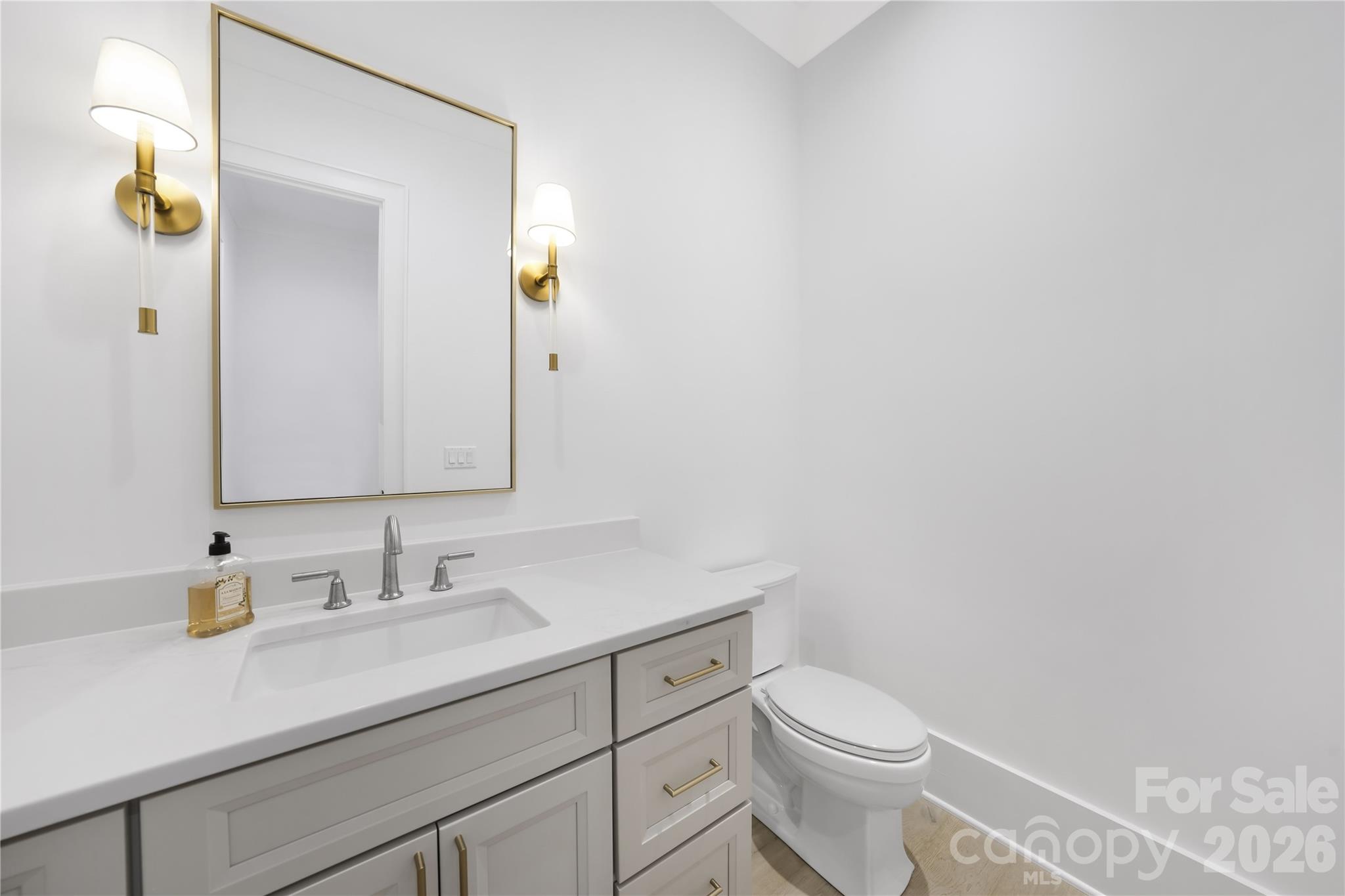 5031 Gilchrist Road, Unit 1A Charlotte, NC 28211 - Photo 23 of 46 a bathroom with a sink a toilet and mirror