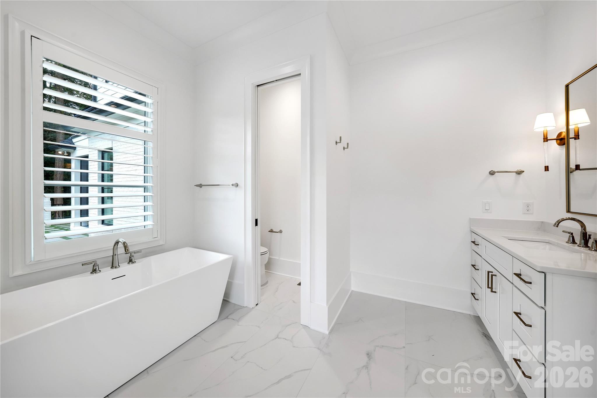 5031 Gilchrist Road, Unit 1A Charlotte, NC 28211 - Photo 31 of 46 a bathroom with a tub sink and mirror