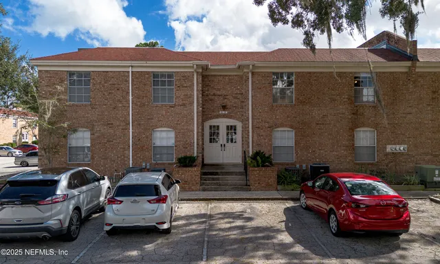 a front view of a house with parking space