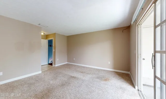 a view of an empty room with a window