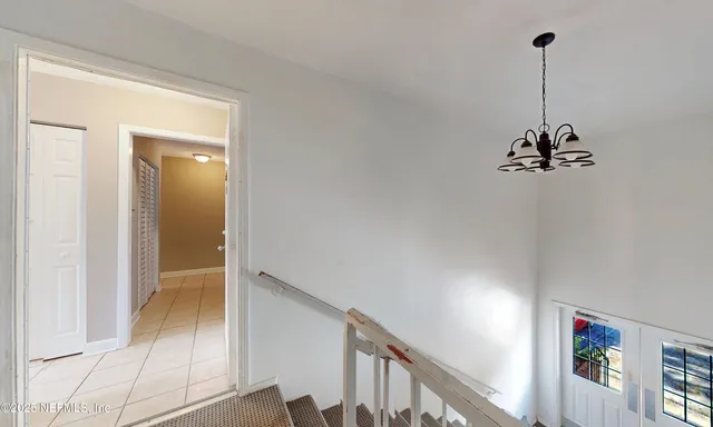 a view of a hallway with chandelier