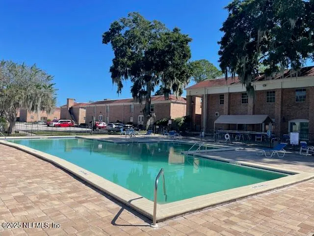 a view of a swimming pool with chairs