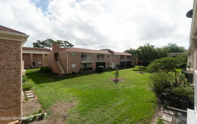 a view of a house with backyard sitting area and garden
