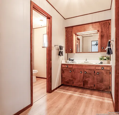 a spacious bathroom with a granite countertop sink and a mirror