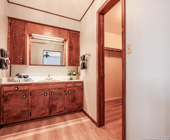 a bathroom with a granite countertop sink vanity and mirror