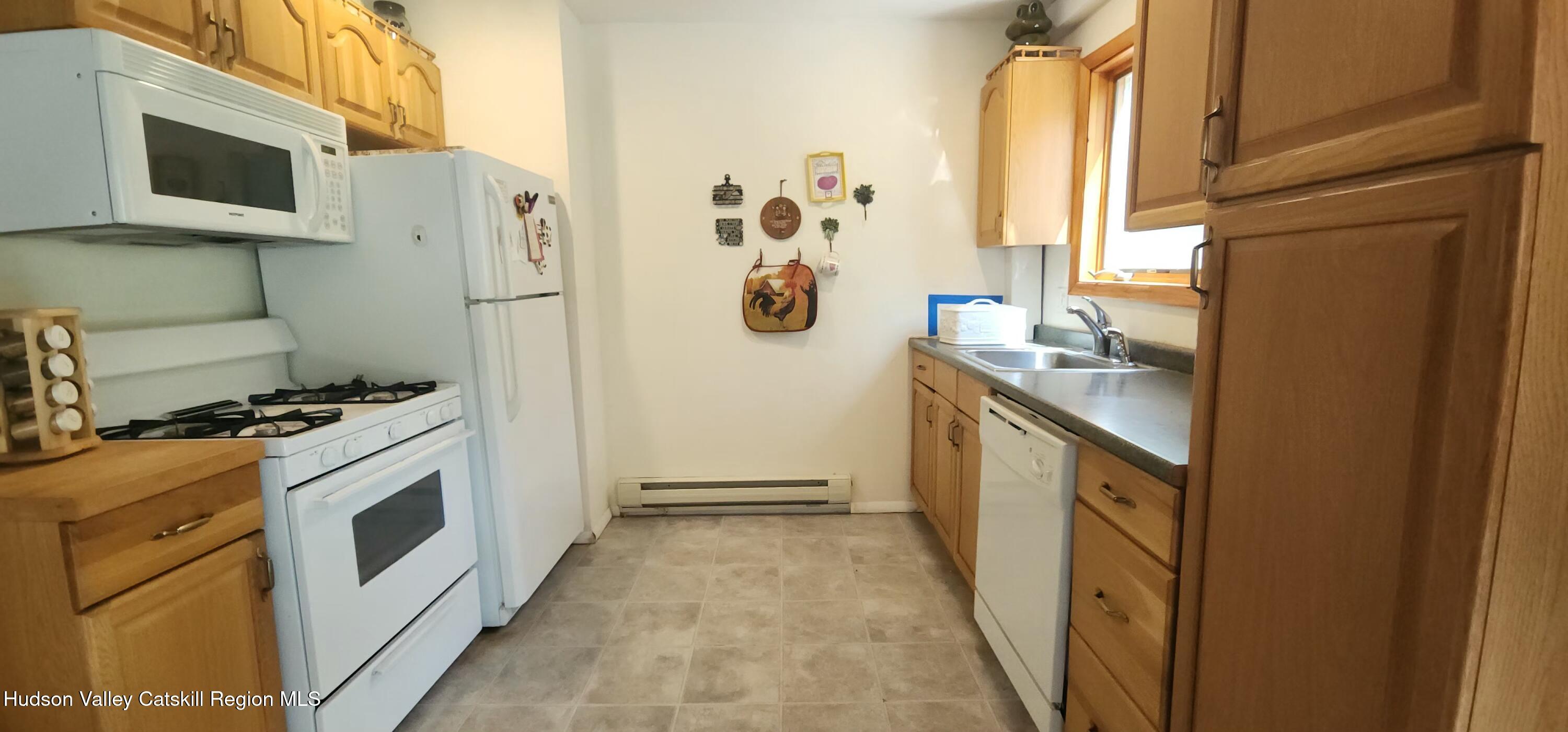436 Big Hollow Road Maplecrest, NY 12454 - Photo 12 of 31 a kitchen with a stove and a refrigerator
