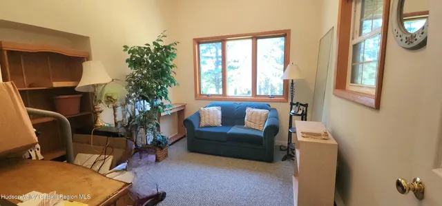 a bedroom with a bed and glass window