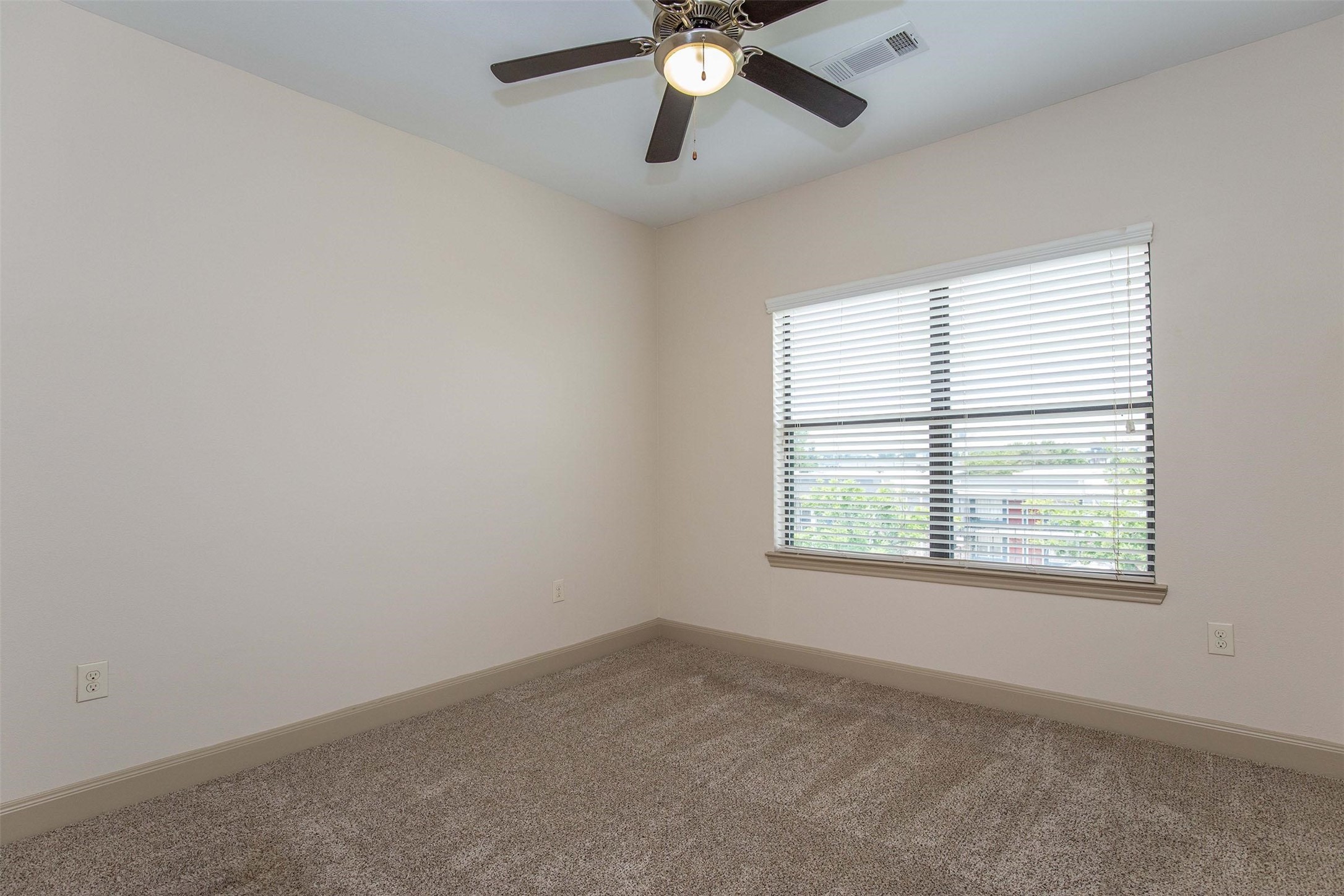 2930 Plum Creek Lane, Unit 2102 Houston, TX 77087 - Photo 6 of 19 an empty room with a window and a fan