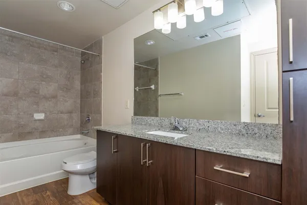 an empty room with ceiling fan and window