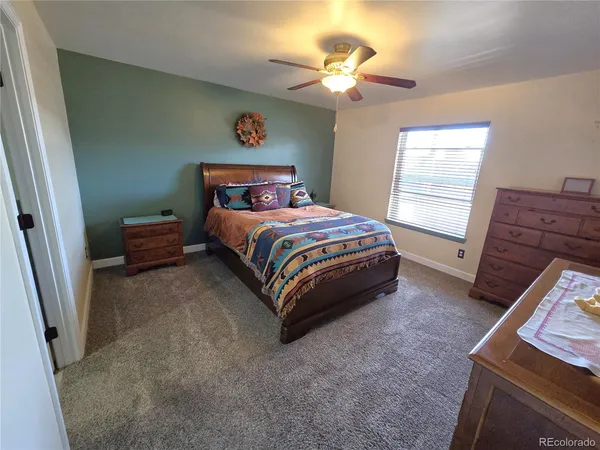 a spacious bedroom with a bed and a chandelier
