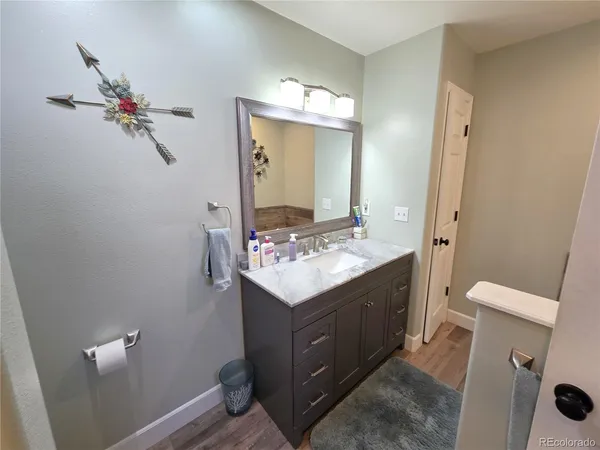 a bathroom with a sink vanity mirror and toilet