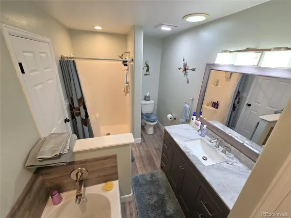 a bathroom with a double vanity sink mirror and shower
