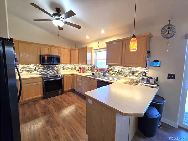 a kitchen with a sink appliances and cabinets