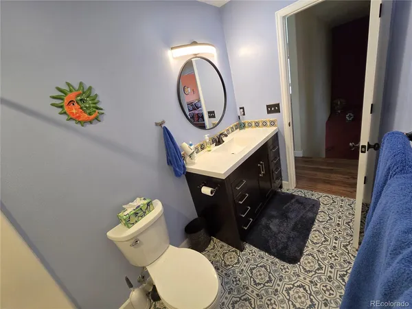 a bathroom with a toilet a sink and a mirror