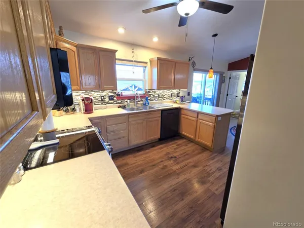 a kitchen with sink a stove and chairs