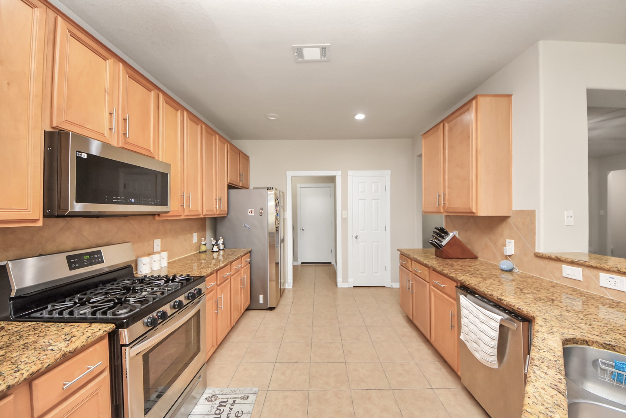 18715 Keystone Oak Street Houston, TX 77084 - Photo 13 of 50 a kitchen with stainless steel appliances granite countertop a stove a sink and a microwave