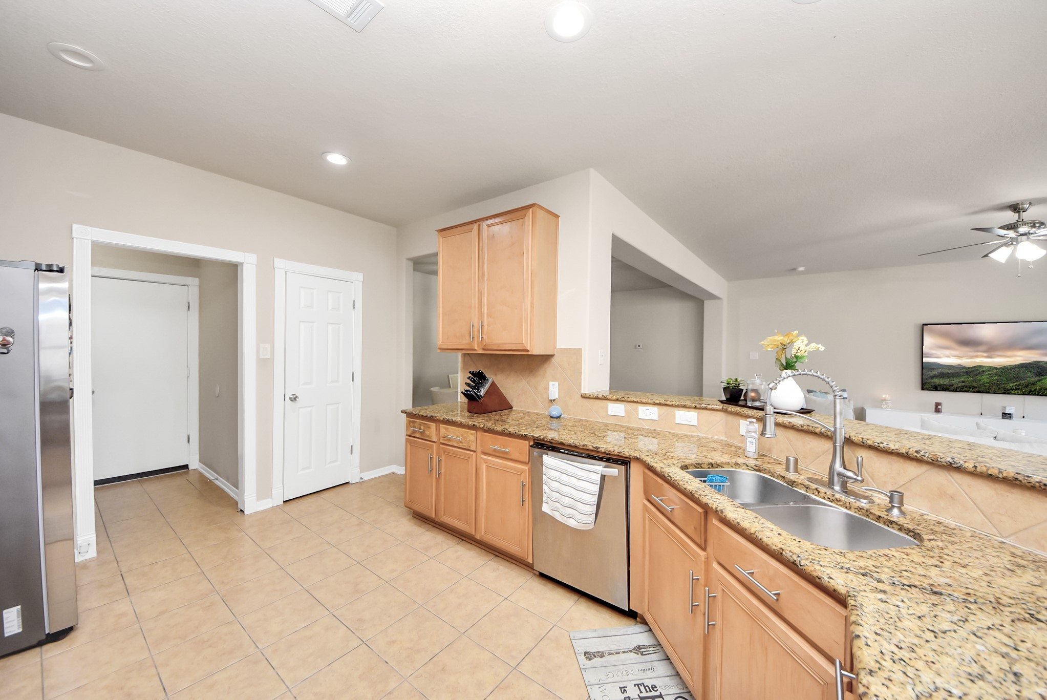 18715 Keystone Oak Street Houston, TX 77084 - Photo 14 of 50 a large kitchen with granite countertop a sink and white cabinets