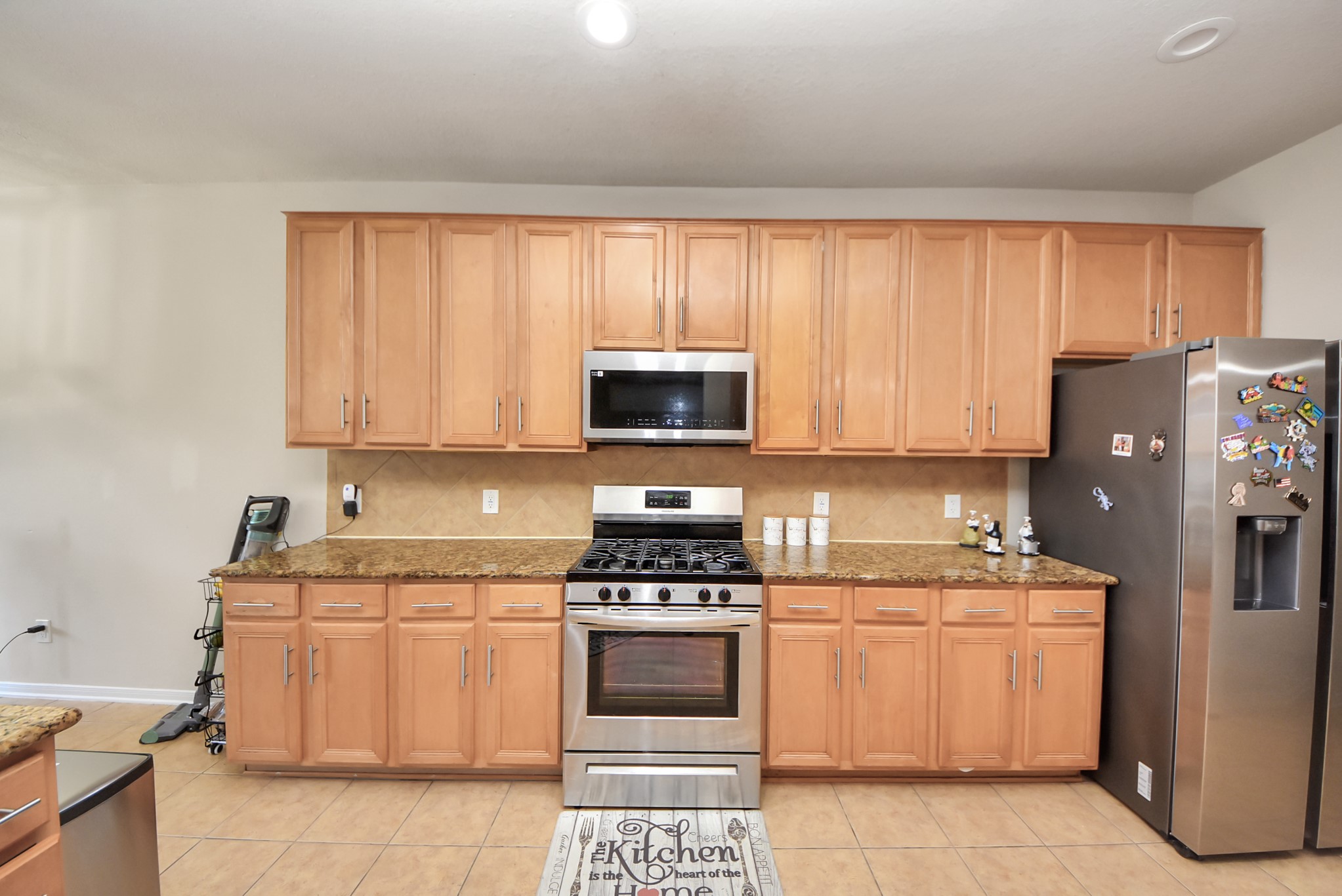 18715 Keystone Oak Street Houston, TX 77084 - Photo 17 of 50 a kitchen with a stove top oven and cabinets