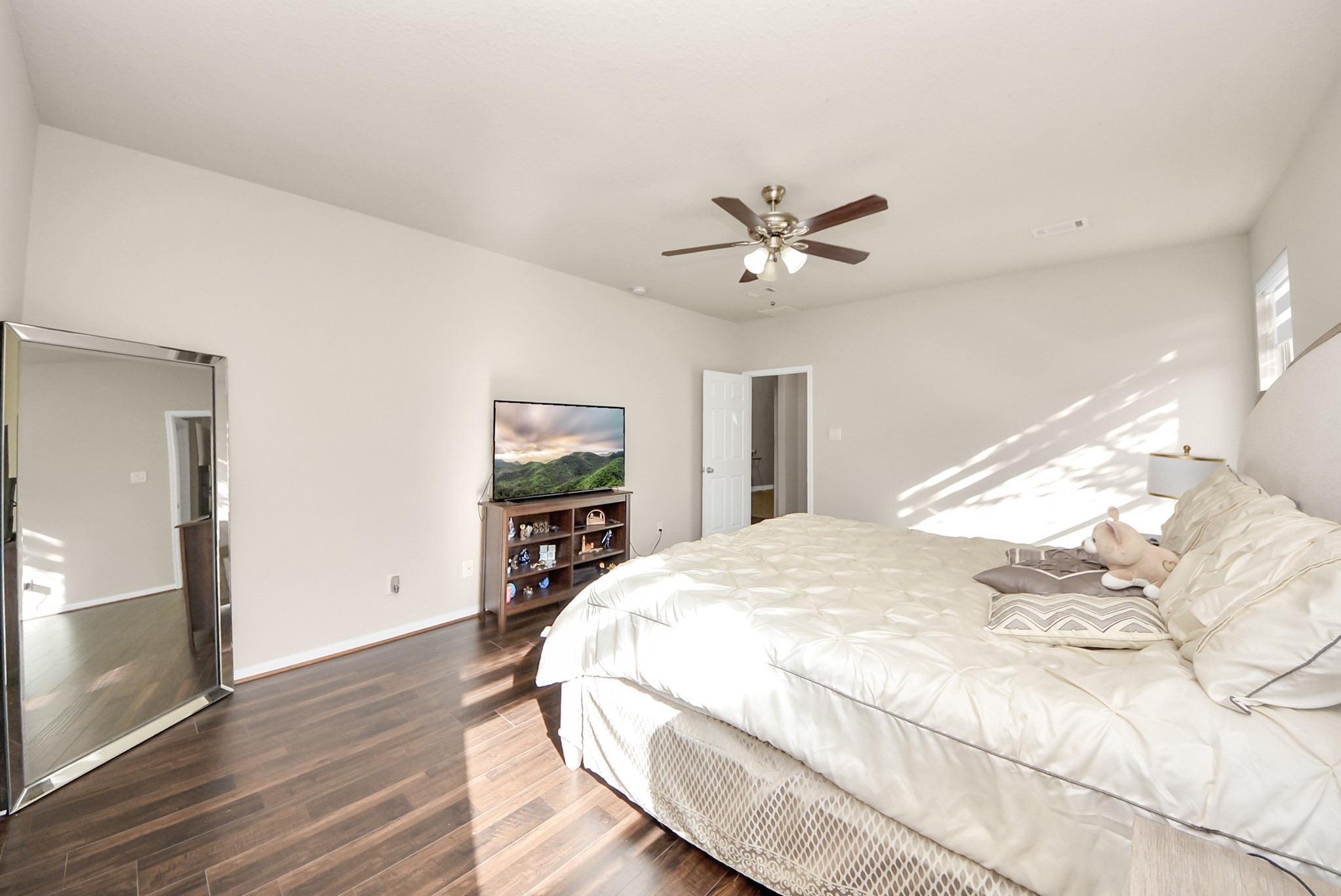 18715 Keystone Oak Street Houston, TX 77084 - Photo 22 of 50 a spacious bedroom with a bed and a chandelier