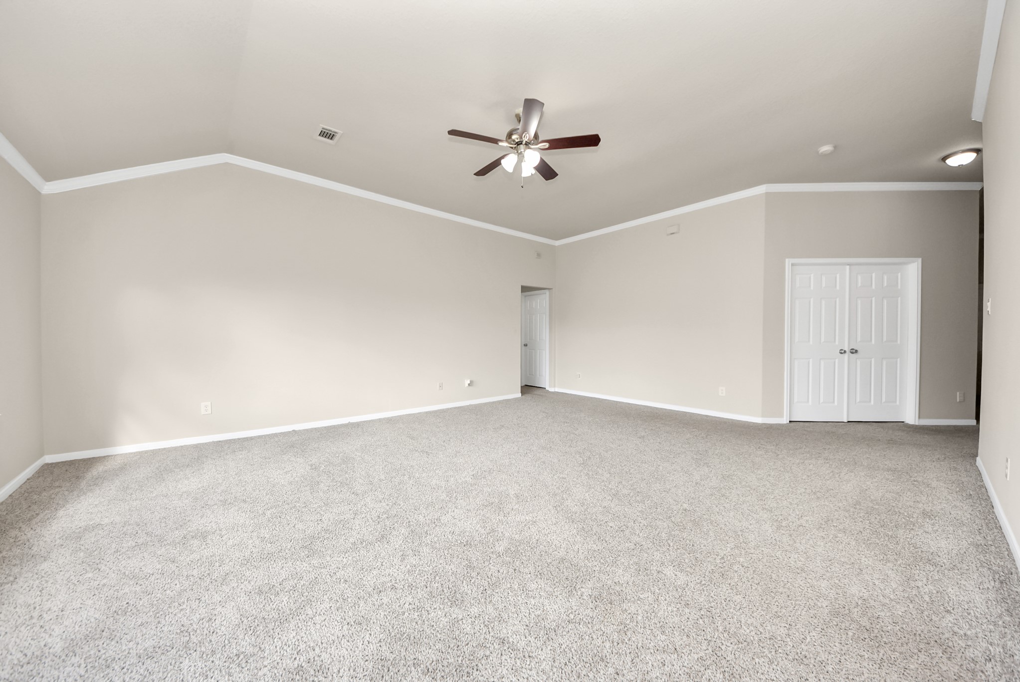 18715 Keystone Oak Street Houston, TX 77084 - Photo 33 of 50 an empty room with chandelier fan and windows