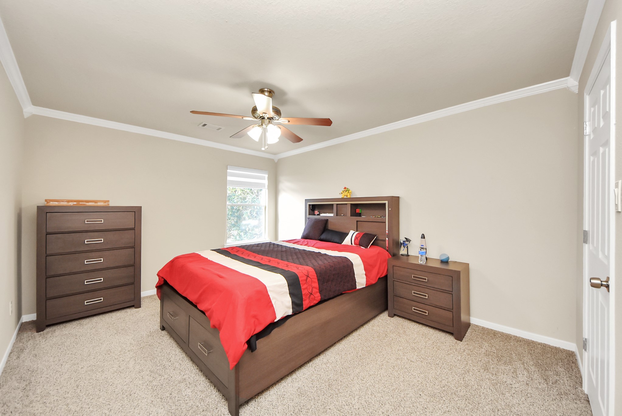18715 Keystone Oak Street Houston, TX 77084 - Photo 40 of 50 a bedroom with a bed and a chandelier
