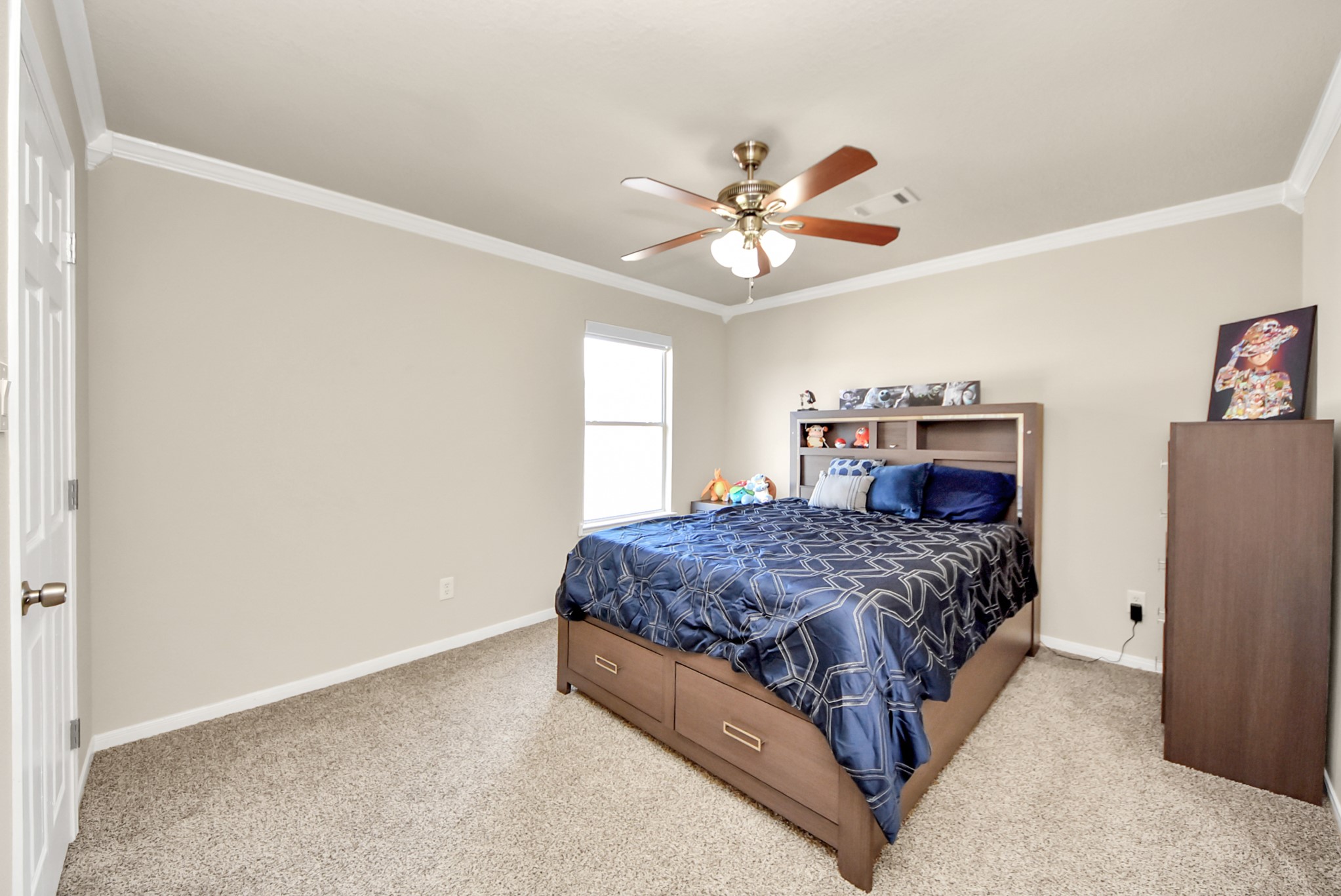 18715 Keystone Oak Street Houston, TX 77084 - Photo 42 of 50 a spacious bedroom with a bed and a chandelier