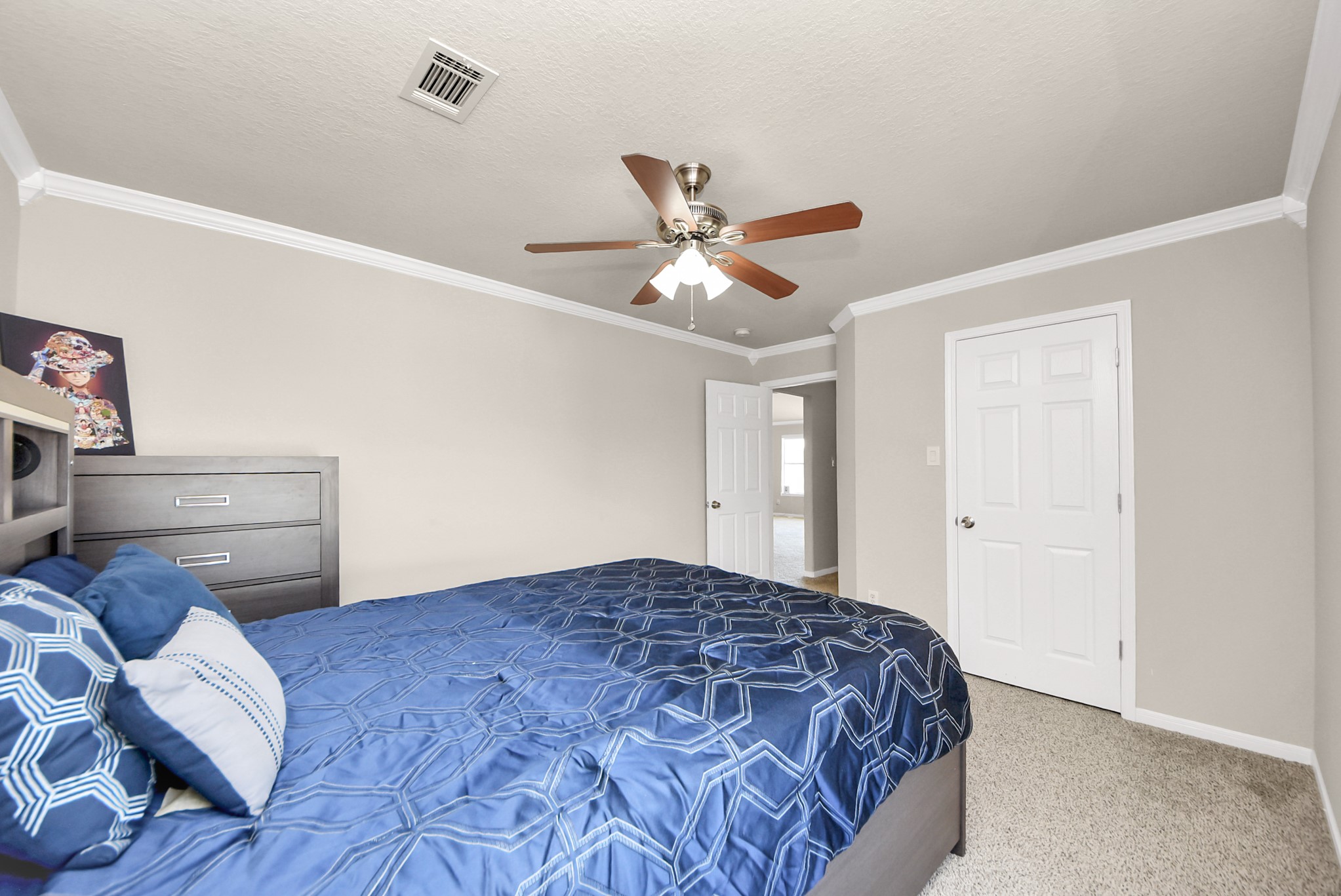 18715 Keystone Oak Street Houston, TX 77084 - Photo 43 of 50 a bedroom with a bed and a chandelier