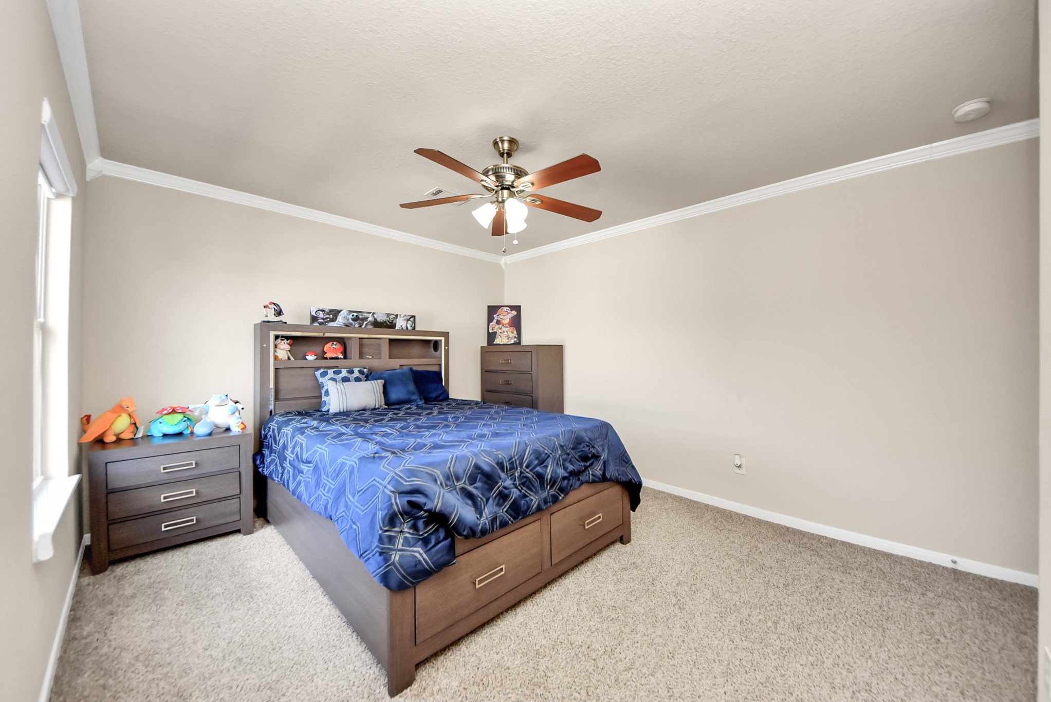 18715 Keystone Oak Street Houston, TX 77084 - Photo 44 of 50 a bedroom with a bed and a chandelier