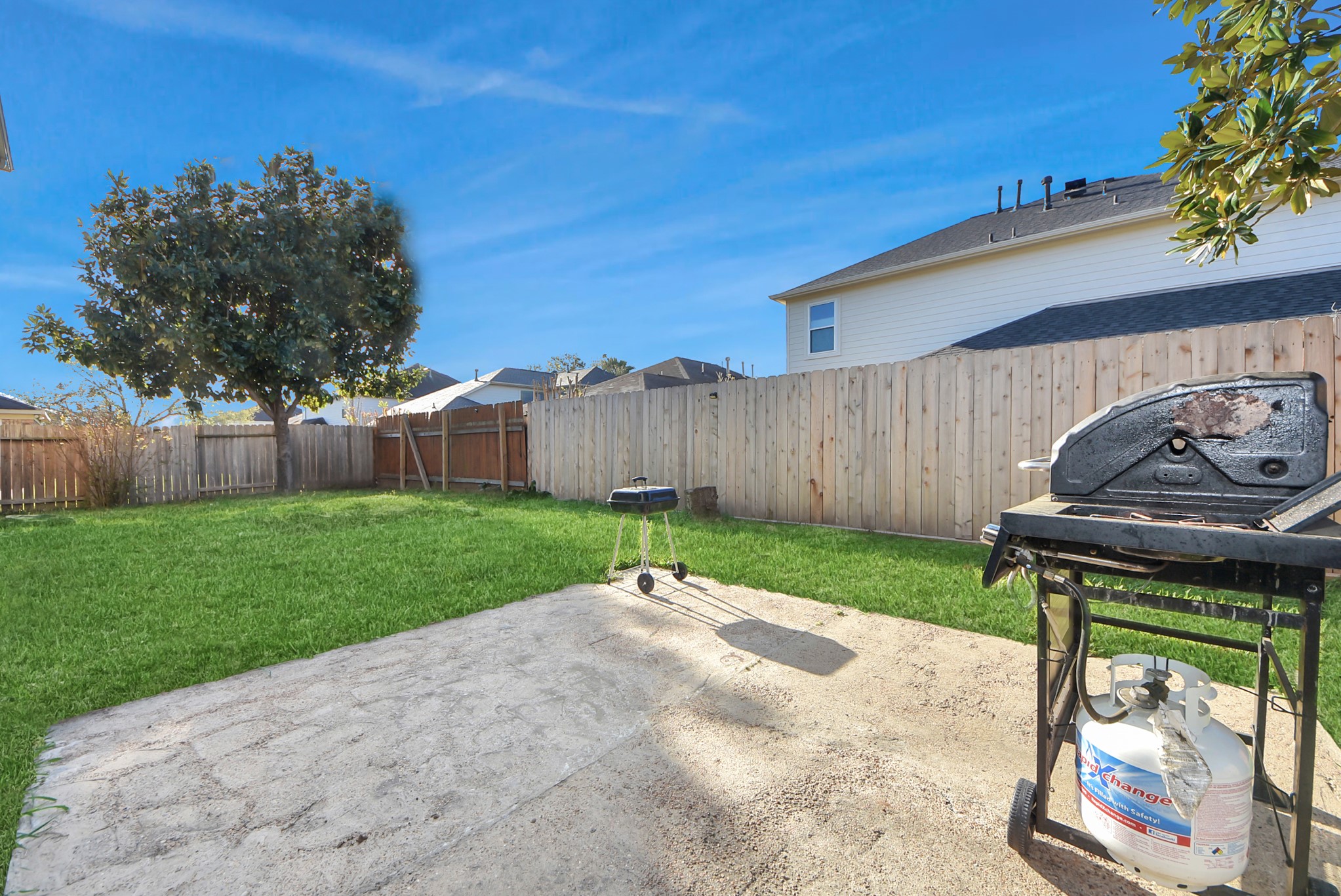 18715 Keystone Oak Street Houston, TX 77084 - Photo 47 of 50 a view of a backyard with table and chairs and a fire pit