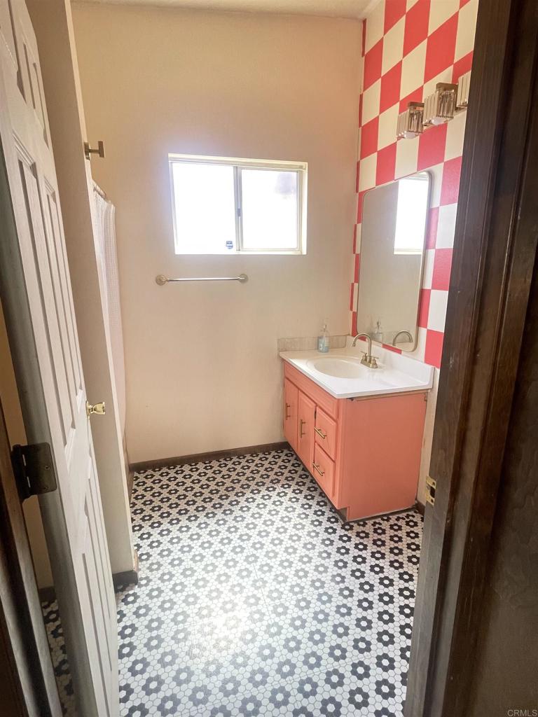 1115 South 6th Street El Centro, CA 92243 - Photo 12 of 19 a bathroom with a sink a toilet a window and vanity