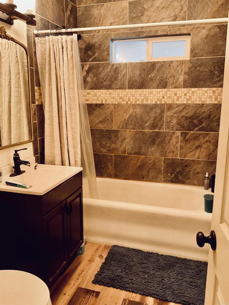 1115 South 6th Street El Centro, CA 92243 - Photo 18 of 19 a bathroom with a bathtub a sink and a shower