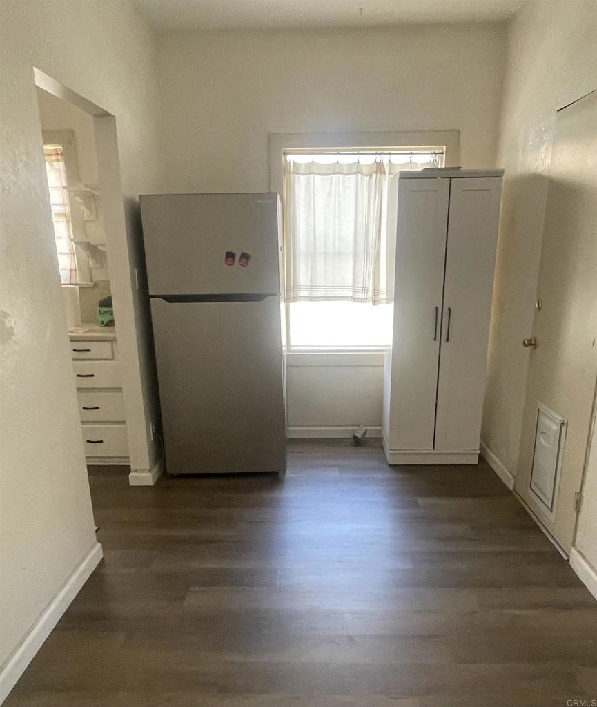 1115 South 6th Street El Centro, CA 92243 - Photo 8 of 19 an empty room with wooden floor and windows