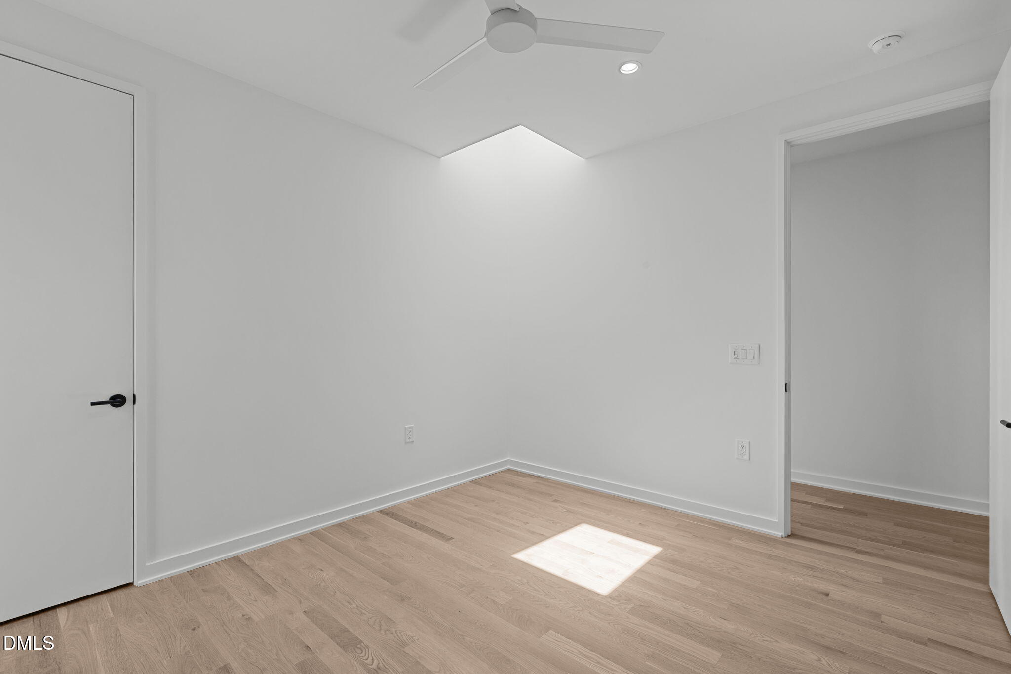 501 South Bloodworth Street, Unit 105 Raleigh, NC 27601 - Photo 35 of 59 a view of an empty room with wooden floor and a window