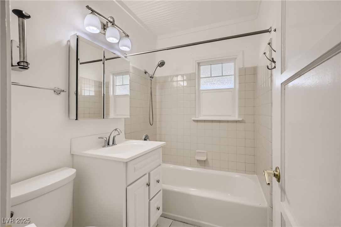 103 West Victory Road Henderson, NV 89015 - Photo 24 of 28 Bathroom featuring toilet, vanity, and bathing tub / shower combination