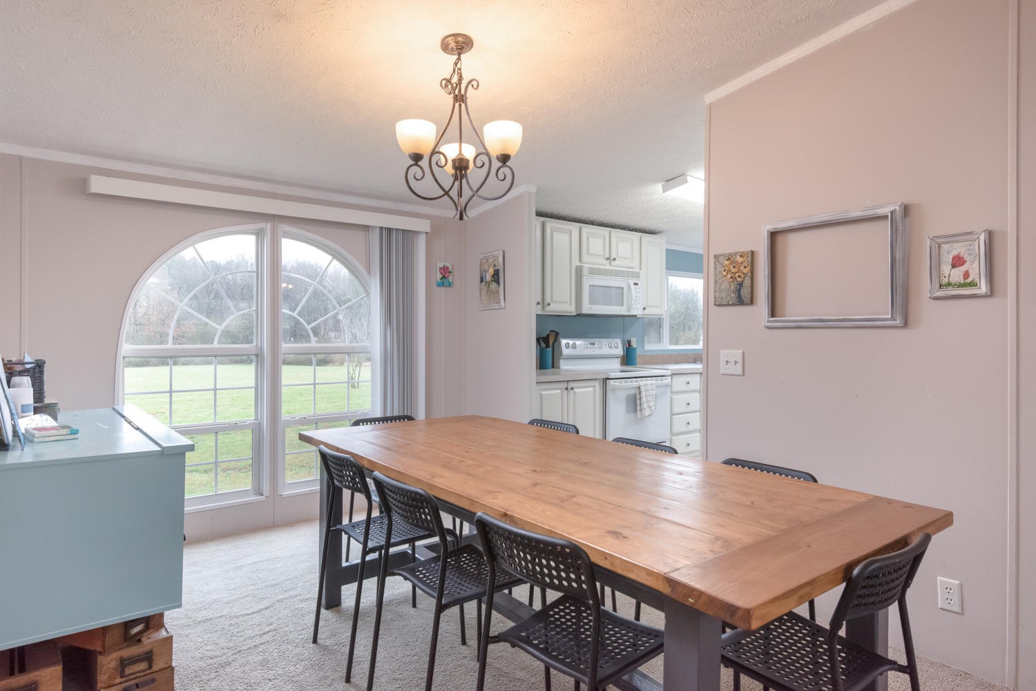929 Hunt Road Cleveland, TN 37323 - Photo 6 of 26 a view of a dining room with furniture a chandelier and wooden floor