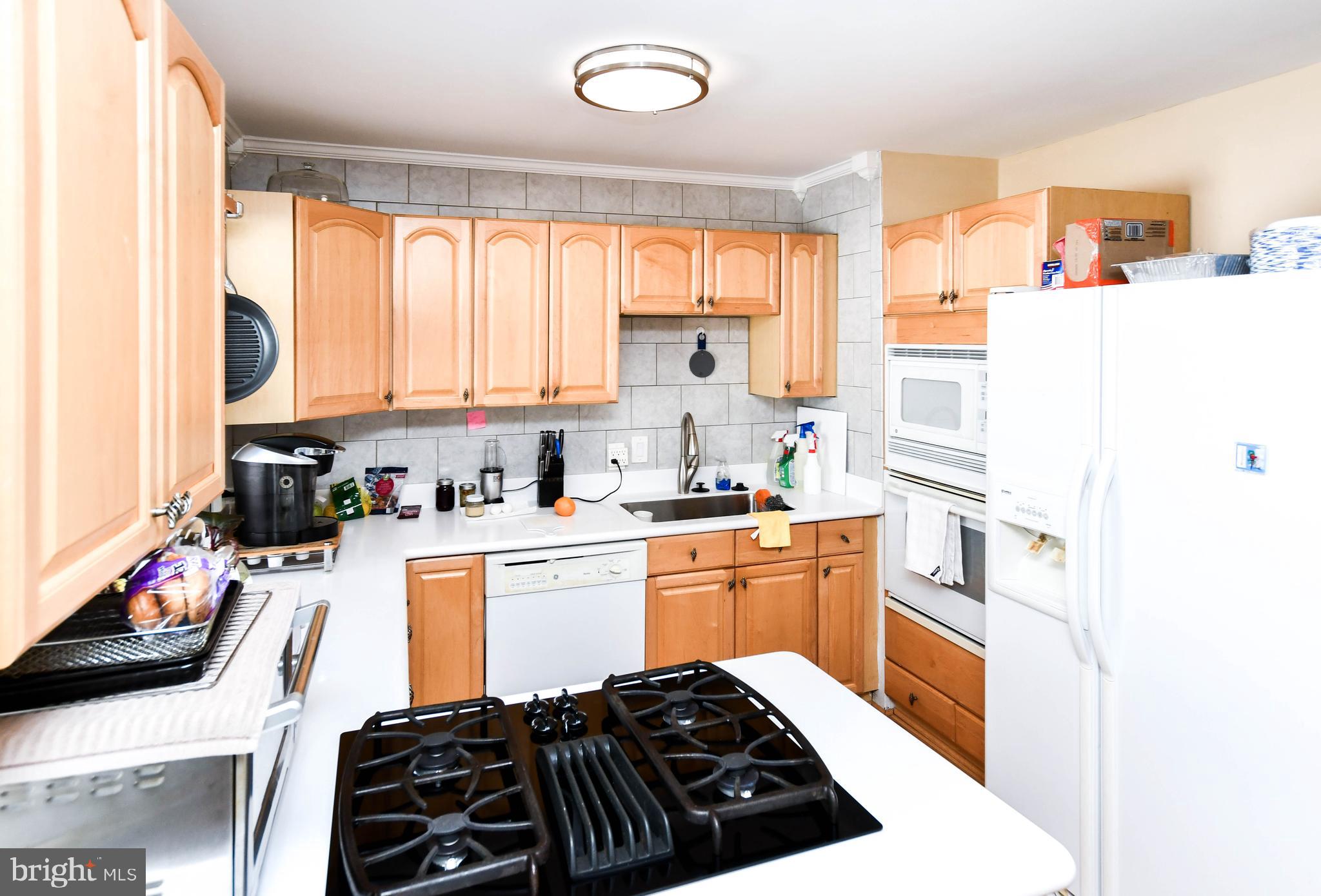 6714 Darby Road Hyattsville, MD 20784 - Photo 11 of 35 a kitchen with stainless steel appliances a stove a sink and a refrigerator